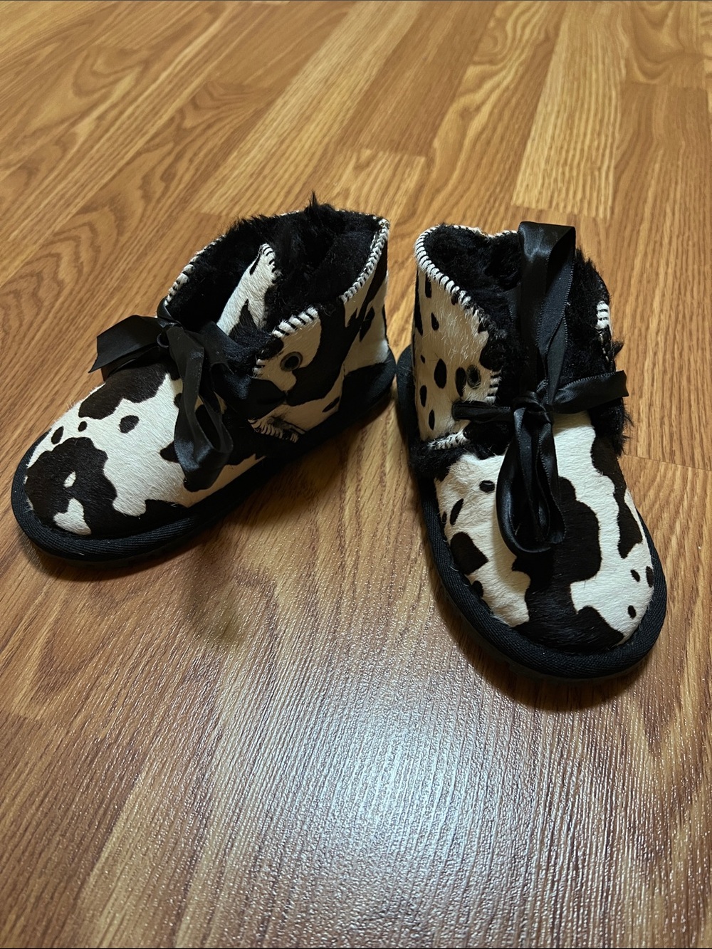 UGG Kids Black & White Cow-Print Plush Booties with Satin Bows